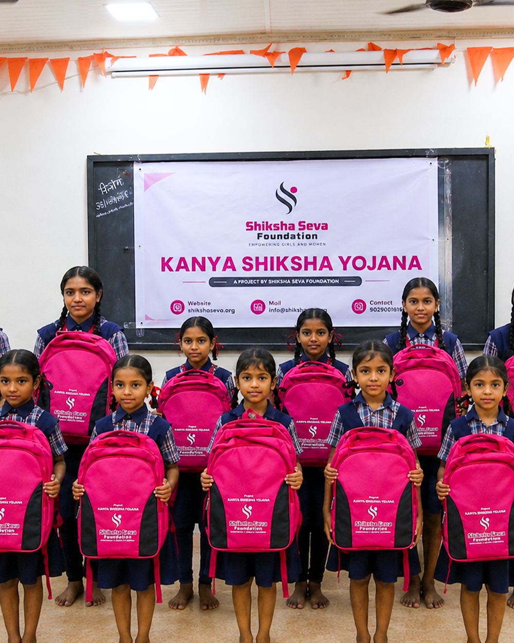 Child receiving a school kit with bag and supplies